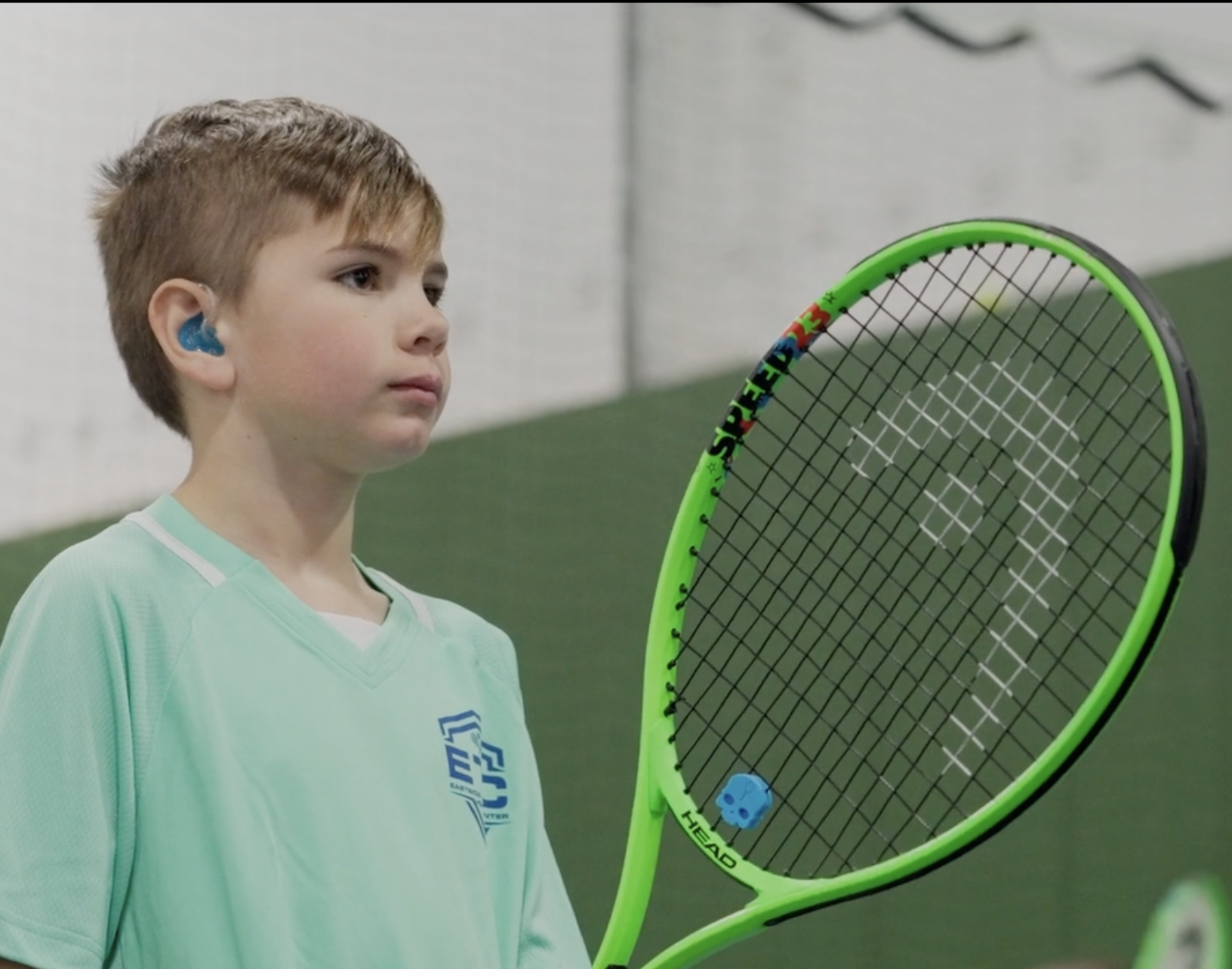 TOPS Tennis student with racquet