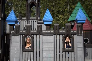 two ladys posing in a castle window drinking fountains in Kirkland parks